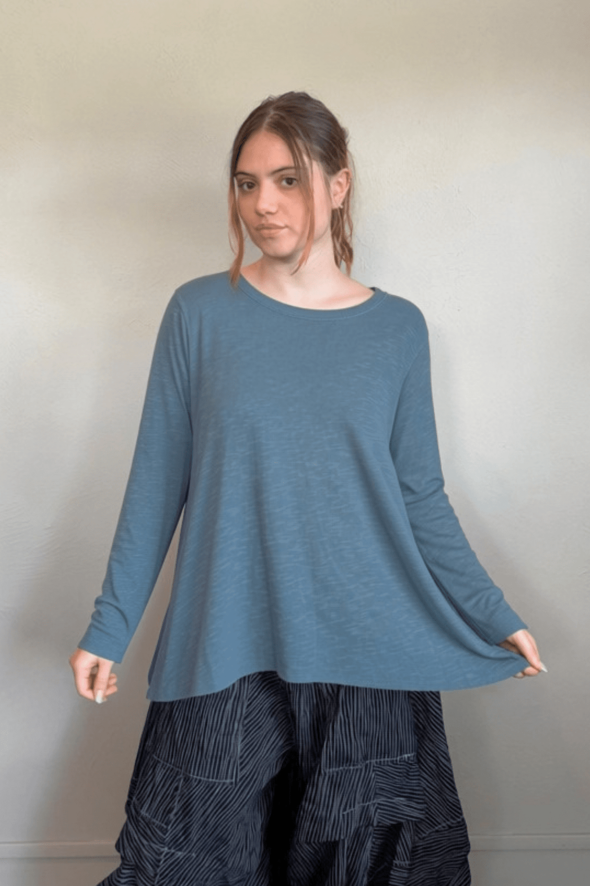 North Star Base by gertie 1153 Long Angle Tee, a relaxed long-sleeve A-line slub-knit top with a wide round neckline and flowing hem, shown in Mustard, Black, and Dusty Denim.