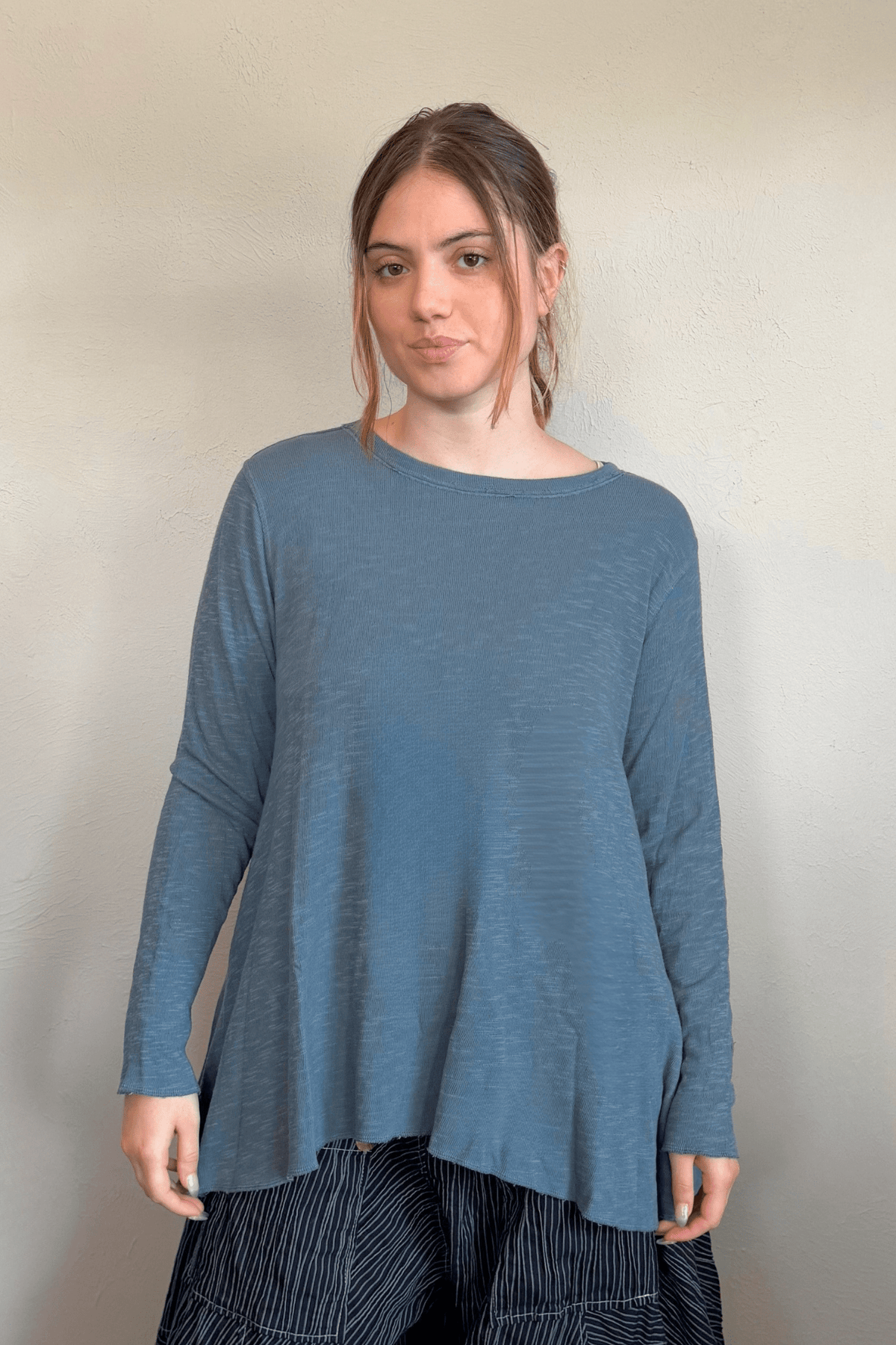 North Star Base by gertie 1153 Long Angle Tee, a relaxed long-sleeve A-line slub-knit top with a wide round neckline and flowing hem, shown in Mustard, Black, and Dusty Denim.