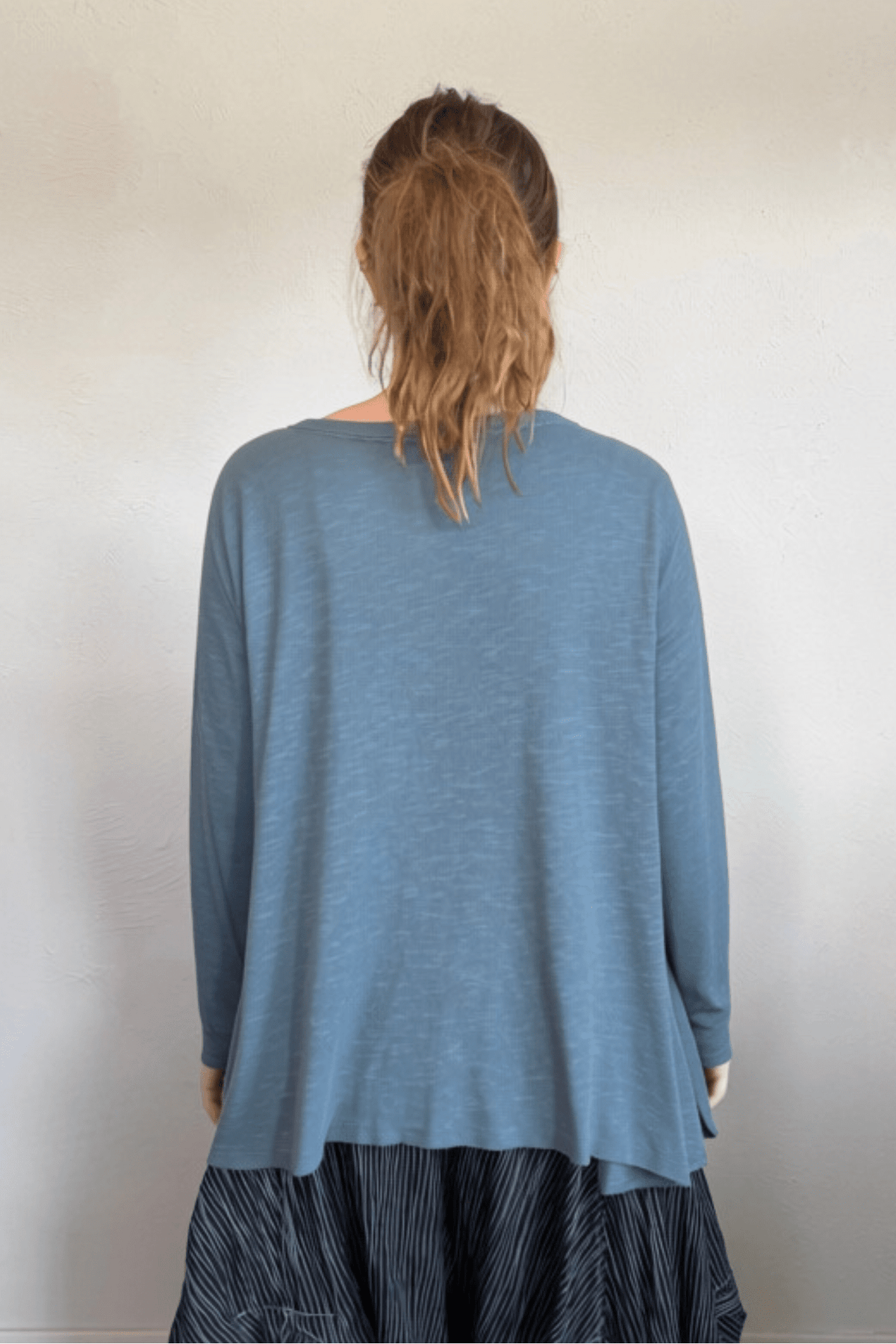 North Star Base by gertie 1153 Long Angle Tee, a relaxed long-sleeve A-line slub-knit top with a wide round neckline and flowing hem, shown in Mustard, Black, and Dusty Denim.