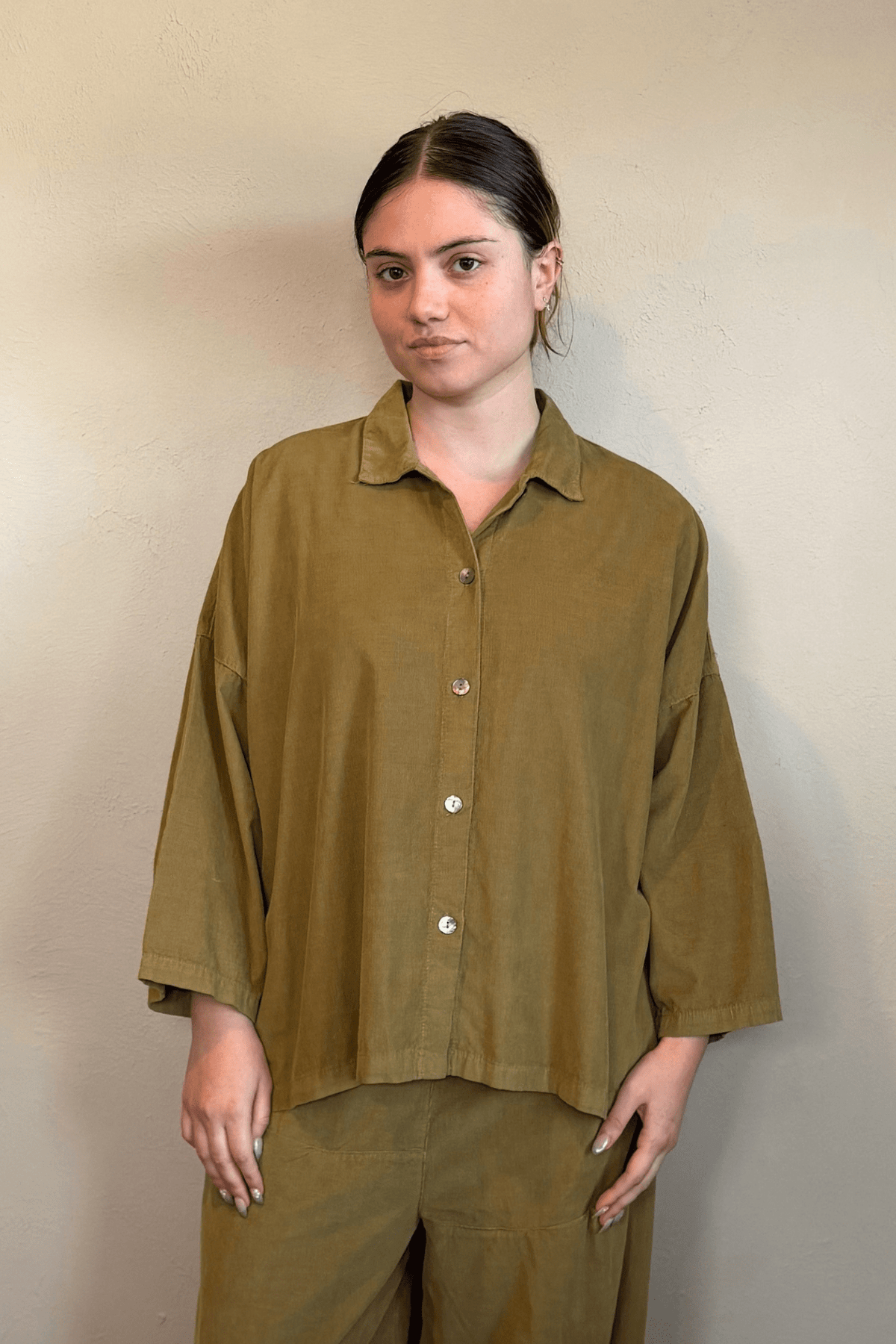 Gertie's 2167 Corduroy Big Shirt, an oversized fine-wale corduroy button-front shirt with point collar, dropped shoulders, wide three-quarter sleeves, side slits, and a longer back hem, shown in black and olive.