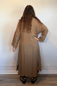 Gertie's 3095 Travel Duster in Winter Olive and Indigo, featuring a long relaxed silhouette, point collar, button front, three-quarter sleeves, crinkled texture, pockets and rounded hem.