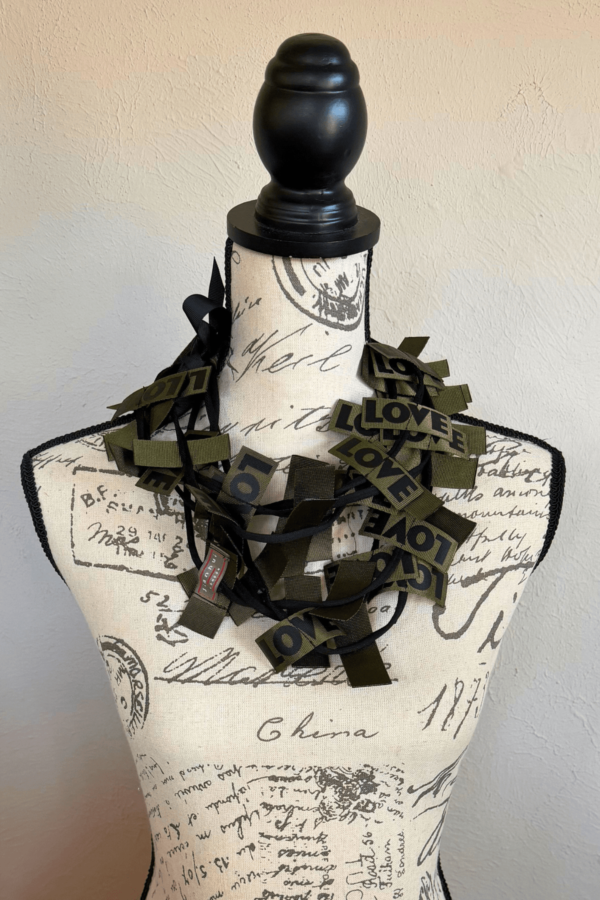 Jianhui 3 Strand Love Ribbon Necklace shown in Charcoal and Olive, styled long and doubled