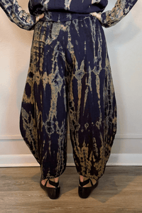 Gertie's 5092Hd Double Pocket Pant in a deep indigo hand-dyed pattern with sage, teal, ochre and muted plum accents, featuring a pull-on waist, large front patch pockets and rounded barrel-leg silhouette.