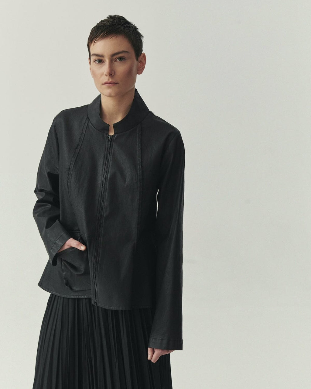Kedziorek 5513 black waxed cotton jacket with stand collar, zip front, asymmetrical pocket and architectural seaming