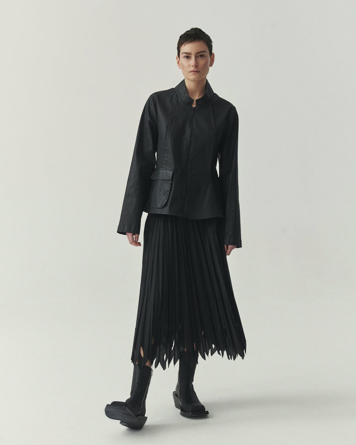 Kedziorek 5513 black waxed cotton jacket with stand collar, zip front, asymmetrical pocket and architectural seaming