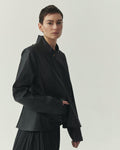Kedziorek 5513 black waxed cotton jacket with stand collar, zip front, asymmetrical pocket and architectural seaming