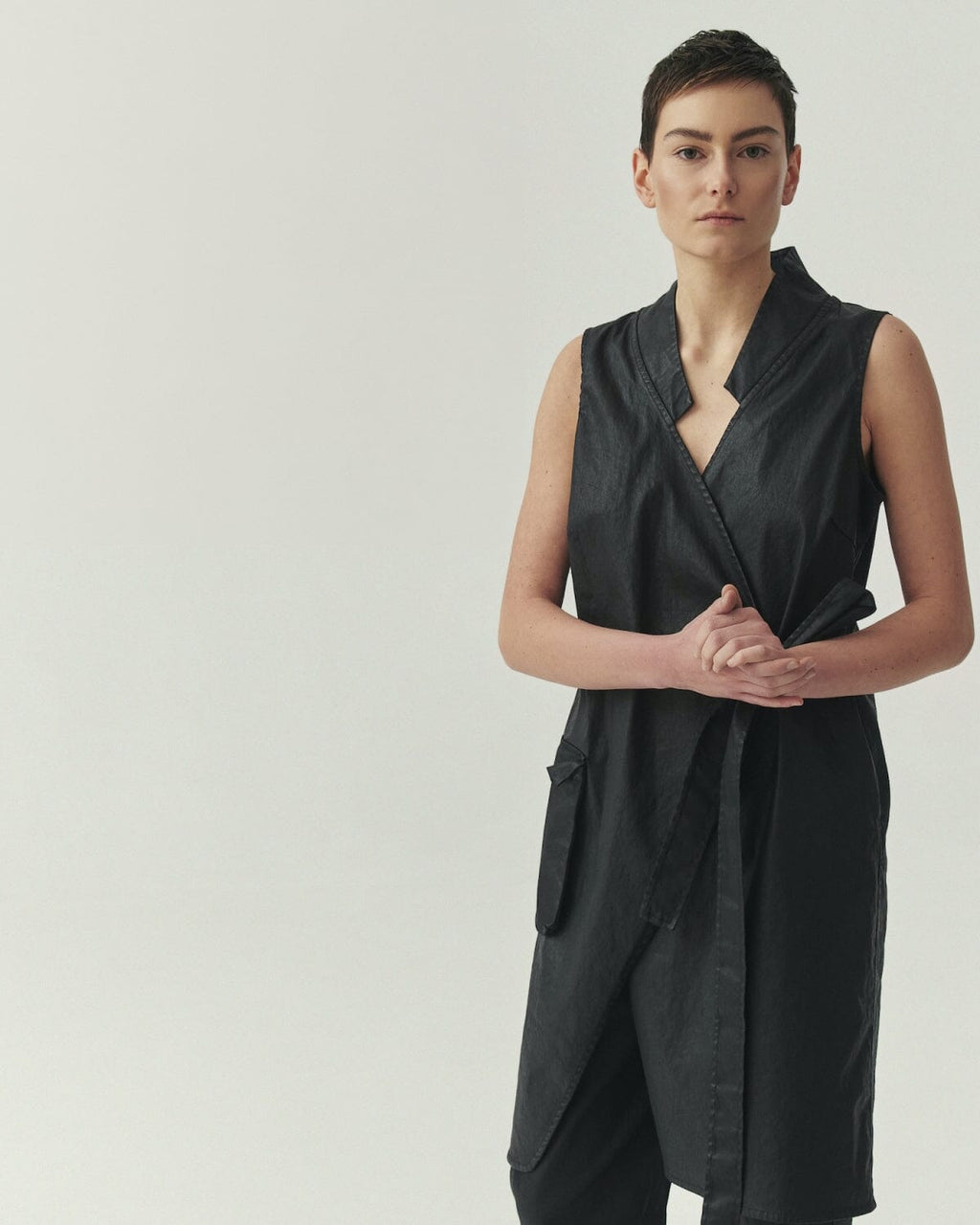 Kedziorek 5514 Vest in black, asymmetrical wrap-front longline sleeveless design with adjustable tie