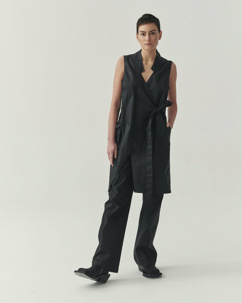 Kedziorek 5514 Vest in black, asymmetrical wrap-front longline sleeveless design with adjustable tie