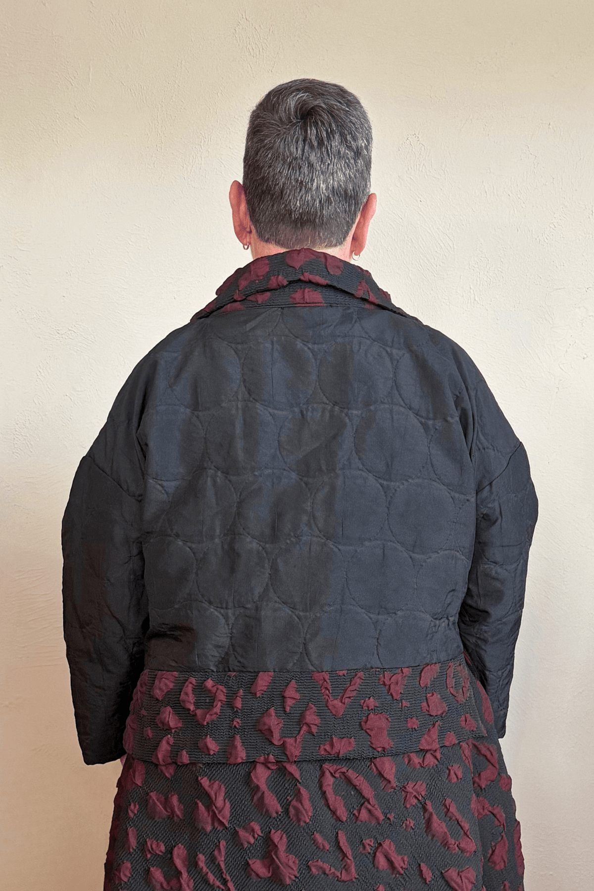 Heydari BRJ Short Jacket in black with quilted body and burgundy patterned accents, front and back views