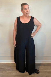 Model wearing the black Kozan Dawn sleeveless wide-leg jumpsuit, shown from front and back.