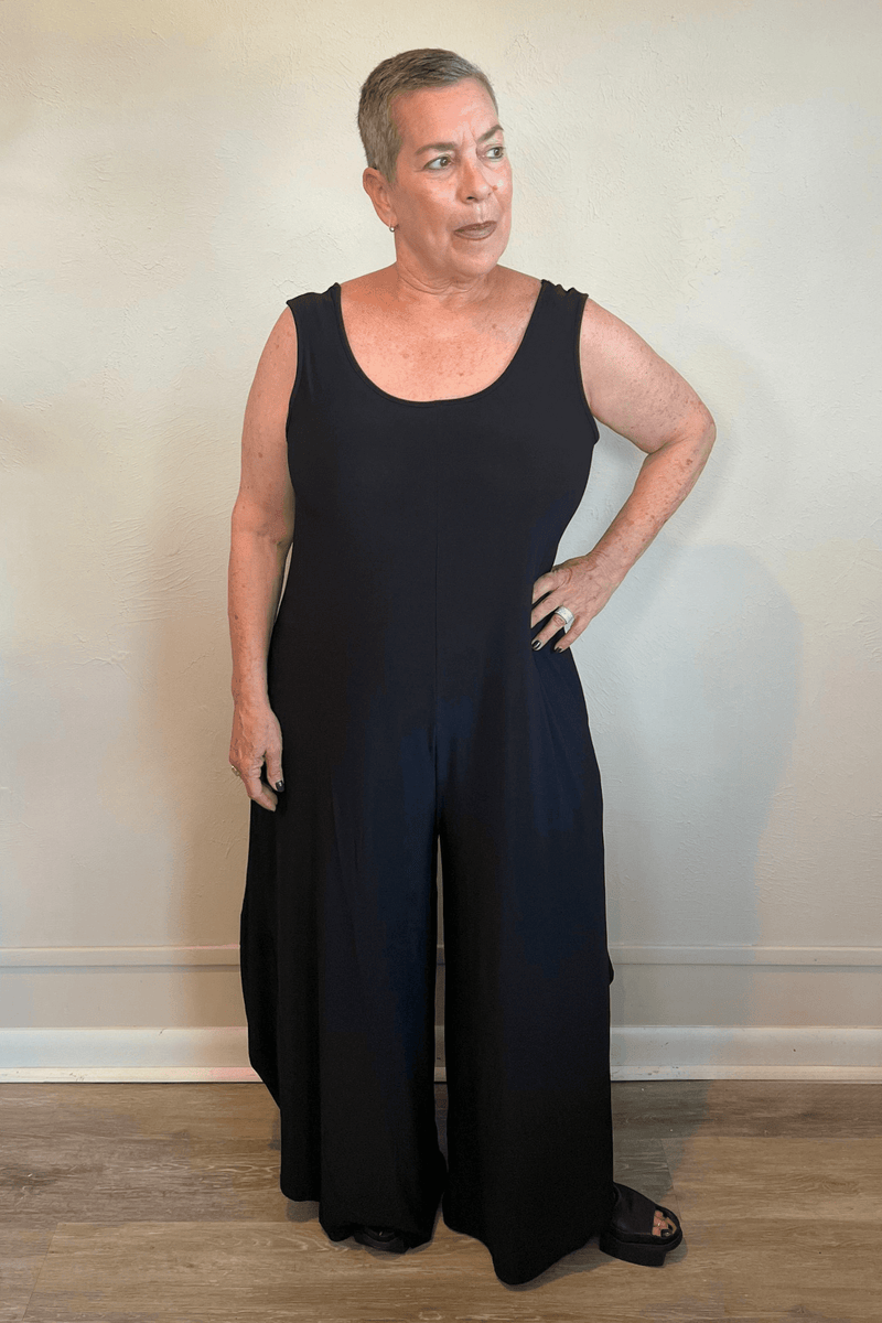 Model wearing the black Kozan Dawn sleeveless wide-leg jumpsuit, shown from front and back.