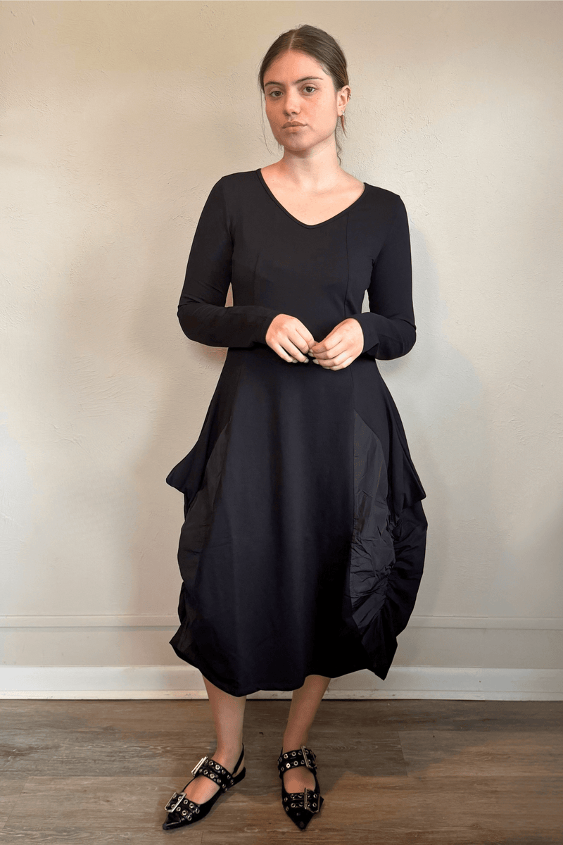 Kozan FT-11096 Via Dress in Nile, shown from front, side, and back with a V-neck, long sleeves, sculptural rounded midi silhouette, and crinkled contrast side panels.
