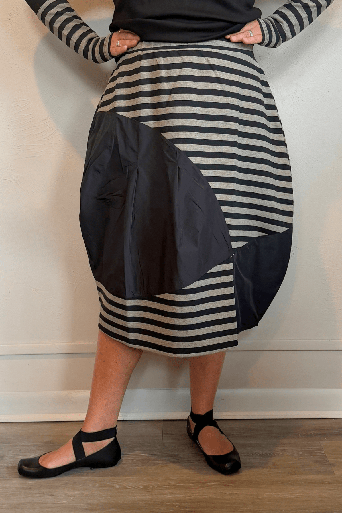 Kozan Fischer midi skirt with horizontal stripes, a full rounded silhouette, and asymmetrical solid contrast panels.