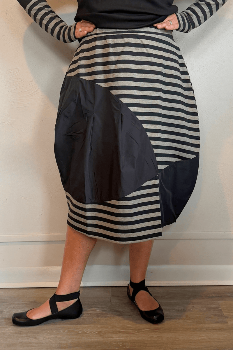 Kozan Fischer midi skirt with horizontal stripes, a full rounded silhouette, and asymmetrical solid contrast panels.