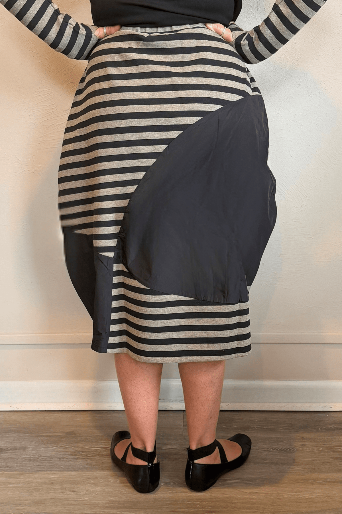 Kozan Fischer midi skirt with horizontal stripes, a full rounded silhouette, and asymmetrical solid contrast panels.
