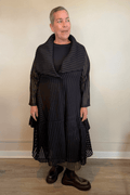 Heydari HOJ black textured openwork mesh jacket with oversized collar and sculptural asymmetrical hem