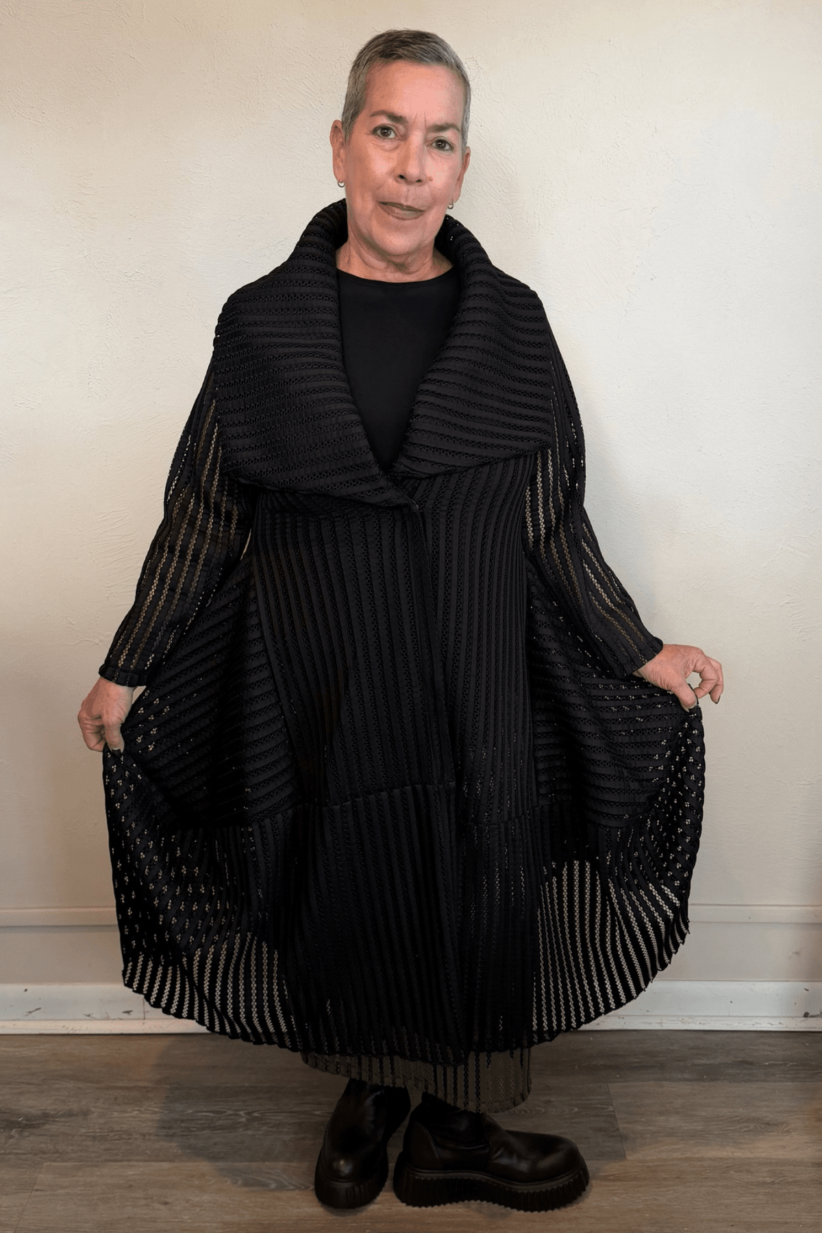Heydari HOJ black textured openwork mesh jacket with oversized collar and sculptural asymmetrical hem