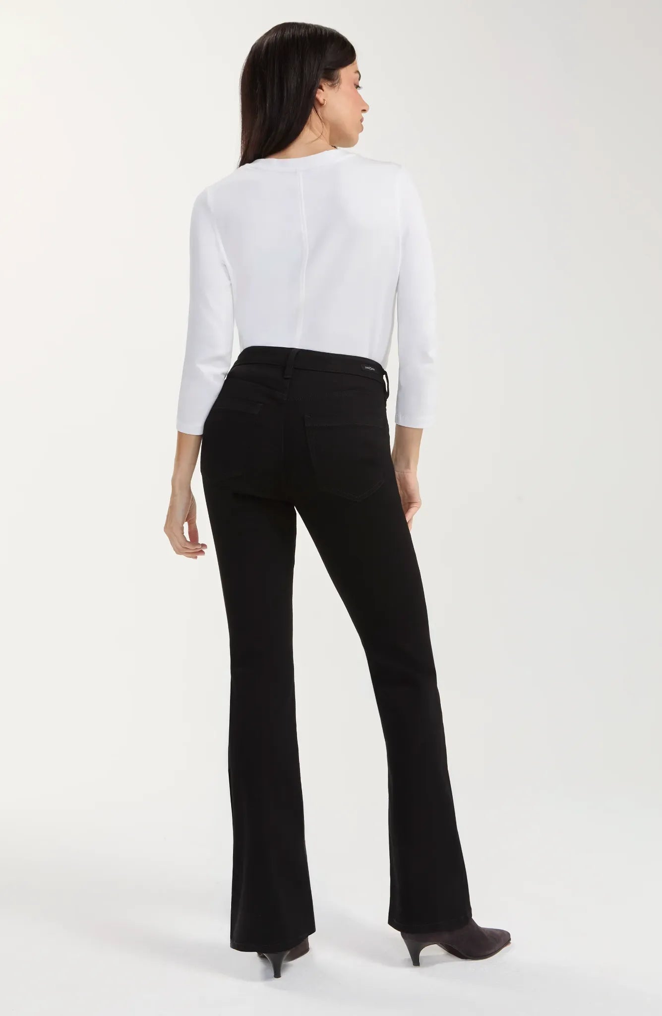 Black rinse baby boot jeans with a mid-rise waist, belt loops, five-pocket styling, zip fly with logo button closure, fitted hip and thigh, and a subtle full-length bootcut leg.
