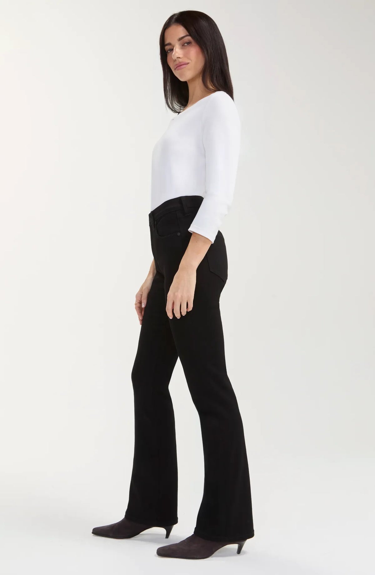 Black rinse baby boot jeans with a mid-rise waist, belt loops, five-pocket styling, zip fly with logo button closure, fitted hip and thigh, and a subtle full-length bootcut leg.