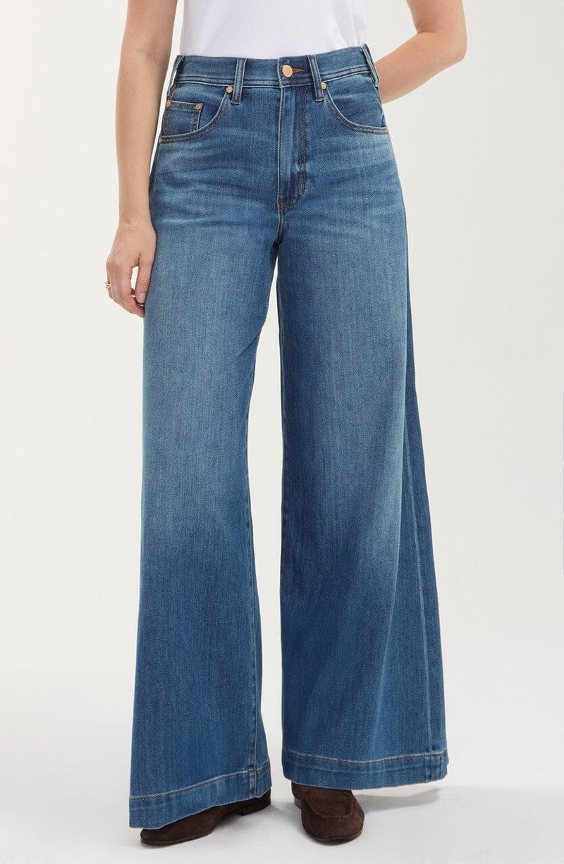 Medium blue high-rise relaxed wide-leg jeans with a full-length silhouette, belt loops, five-pocket styling, zip fly with button closure, and subtle fading.