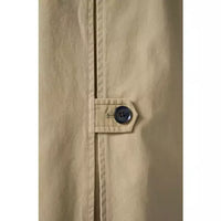 Tan raglan-sleeve coat with a straight relaxed silhouette, front button closure, angled welt pockets, long sleeves with button-tab cuffs, contrast houndstooth stand collar, and a center back inverted pleat with buttoned tab detail.