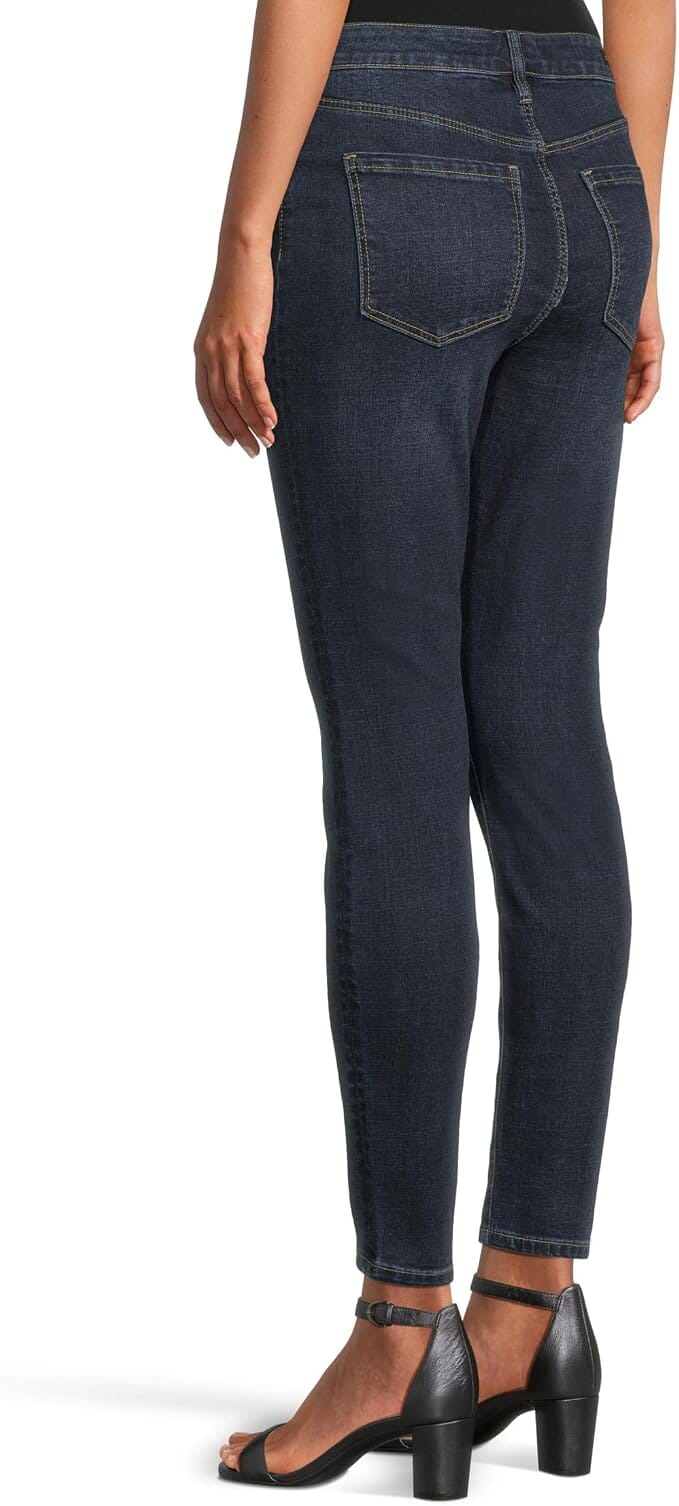 Dark indigo ankle-length skinny jeans with a mid-rise waist, belt loops, five-pocket styling, zip fly with button closure, subtle fading, and a slim streamlined leg.
