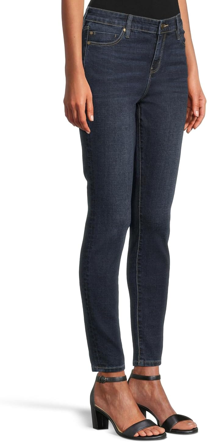 Dark indigo ankle-length skinny jeans with a mid-rise waist, belt loops, five-pocket styling, zip fly with button closure, subtle fading, and a slim streamlined leg.