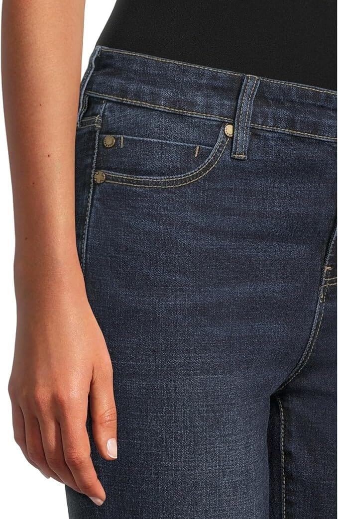 Dark indigo ankle-length skinny jeans with a mid-rise waist, belt loops, five-pocket styling, zip fly with button closure, subtle fading, and a slim streamlined leg.