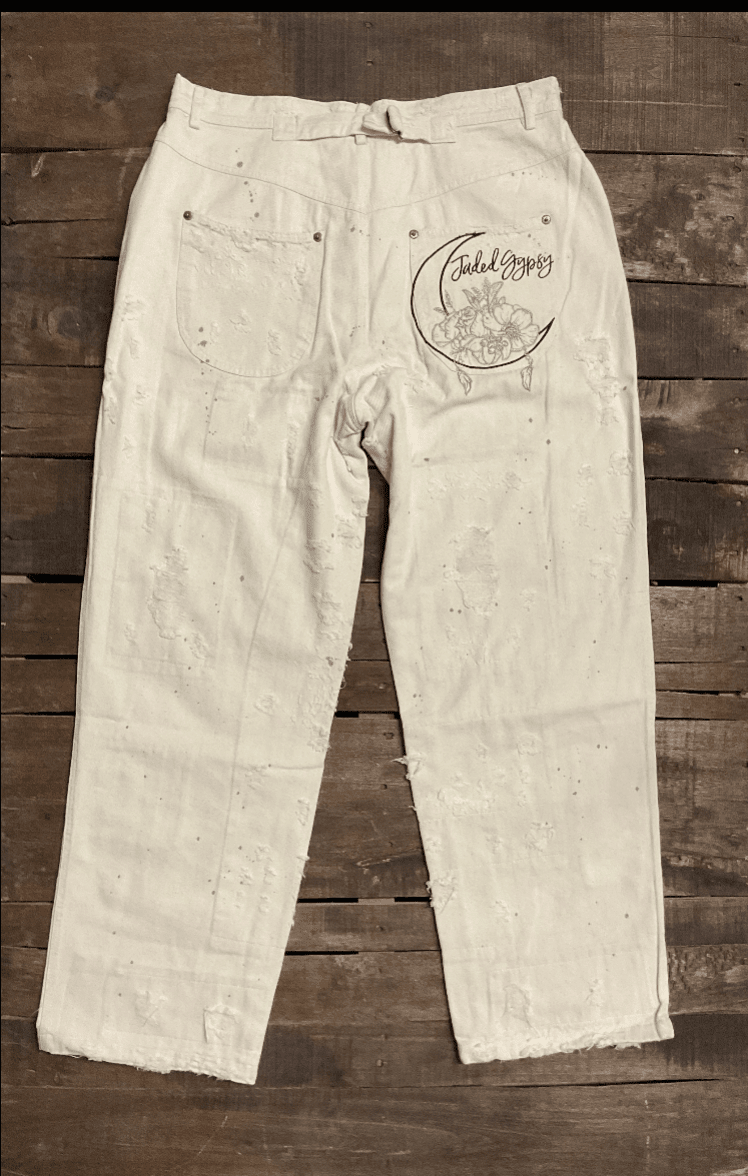 Jaded Gypsy Parchment Peace And Love Jeans with distressed details, PEACE leg graphic, floral artwork, and embroidered back design