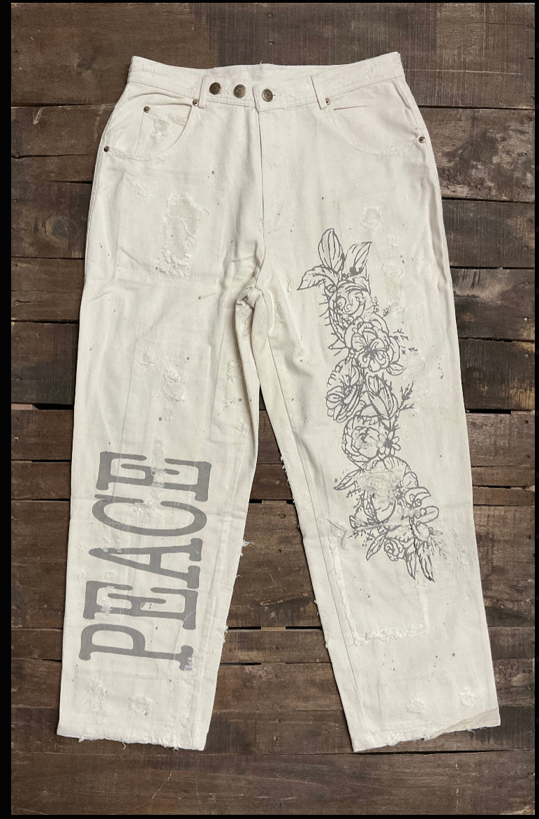 Jaded Gypsy Parchment Peace And Love Jeans with distressed details, PEACE leg graphic, floral artwork, and embroidered back design
