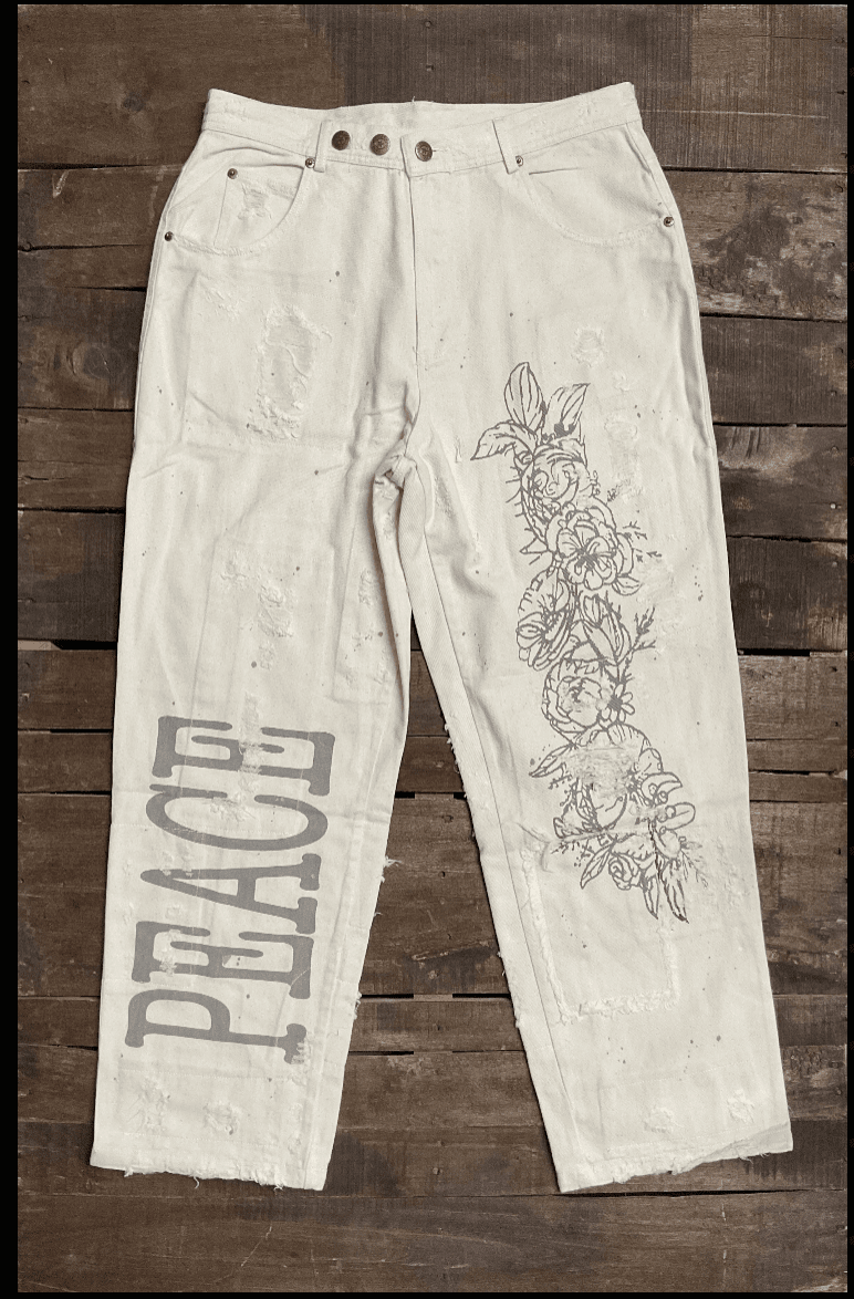 Jaded Gypsy Parchment Peace And Love Jeans with distressed details, PEACE leg graphic, floral artwork, and embroidered back design