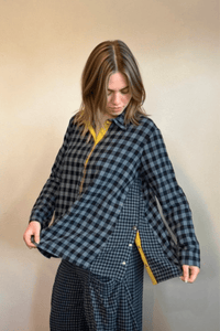 Gertie's 2077B Plackett Gussett Top, a blue-and-black check flannel shirt with long sleeves, metal front snaps, contrasting check side gussets, and yellow placket trim.