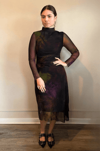 Kozan SH-11058 Mack Dress in Loden, shown from front and back with abstract painterly print, sheer long sleeves, high neckline, and layered asymmetrical midi hem.