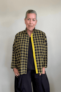 Gertie's 2165B Big Shirt in olive-and-black check cotton flannel, with a relaxed boxy silhouette, point collar, three-quarter sleeves, metal snap front, and bright yellow contrast placket trim.