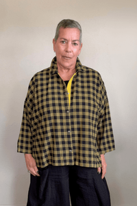Gertie's 2165B Big Shirt in olive-and-black check cotton flannel, with a relaxed boxy silhouette, point collar, three-quarter sleeves, metal snap front, and bright yellow contrast placket trim.