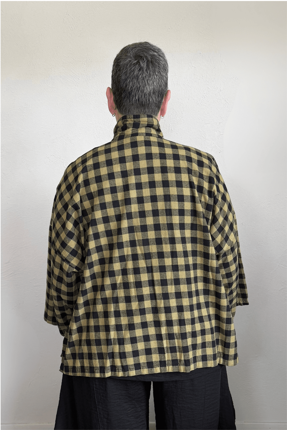 Gertie's 2165B Big Shirt in olive-and-black check cotton flannel, with a relaxed boxy silhouette, point collar, three-quarter sleeves, metal snap front, and bright yellow contrast placket trim.