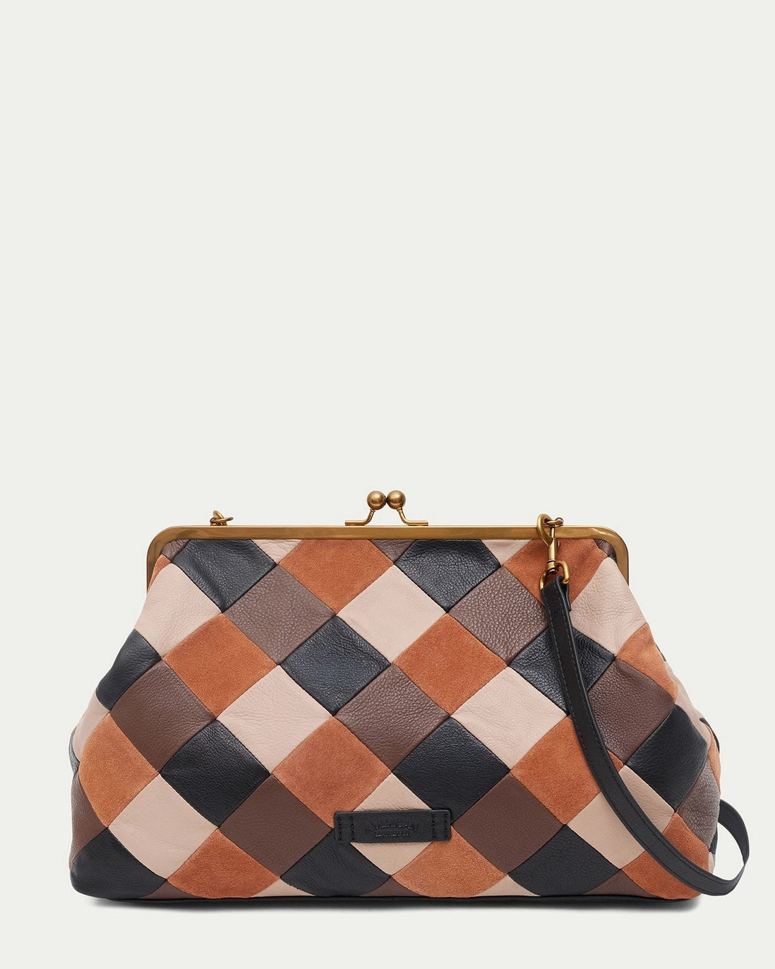 American Leather Co. Grace Oversized Clutch with woven leather patchwork, vintage-inspired kisslock frame, and removable crossbody strap.