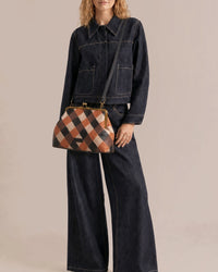 American Leather Co. Grace Oversized Clutch with woven leather patchwork, vintage-inspired kisslock frame, and removable crossbody strap.