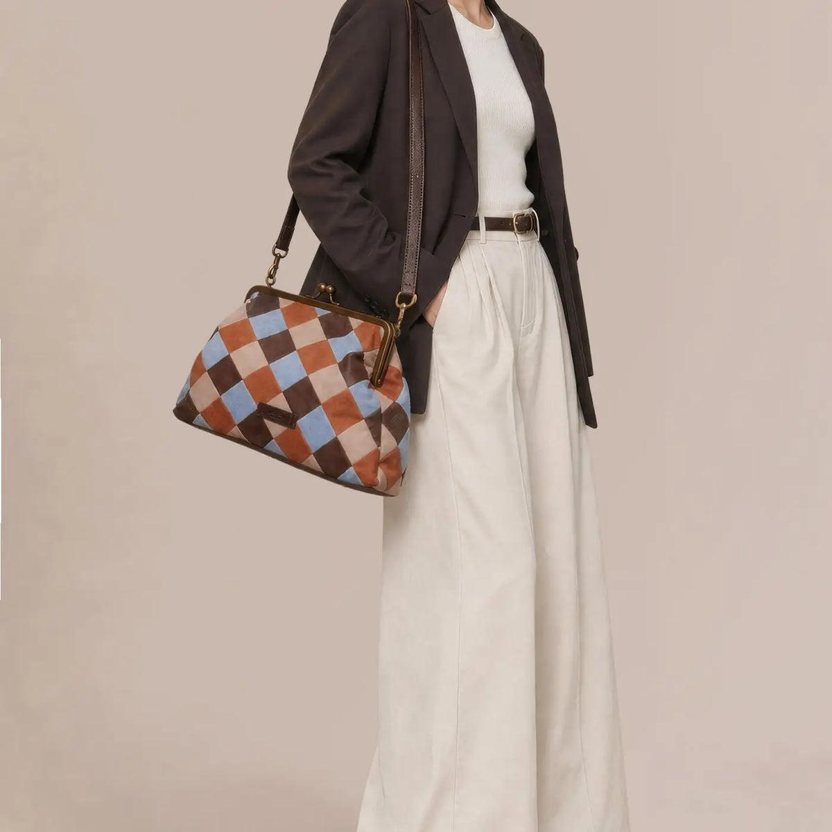 American Leather Co. Grace Oversized Clutch with woven leather patchwork, vintage-inspired kisslock frame, and removable crossbody strap.