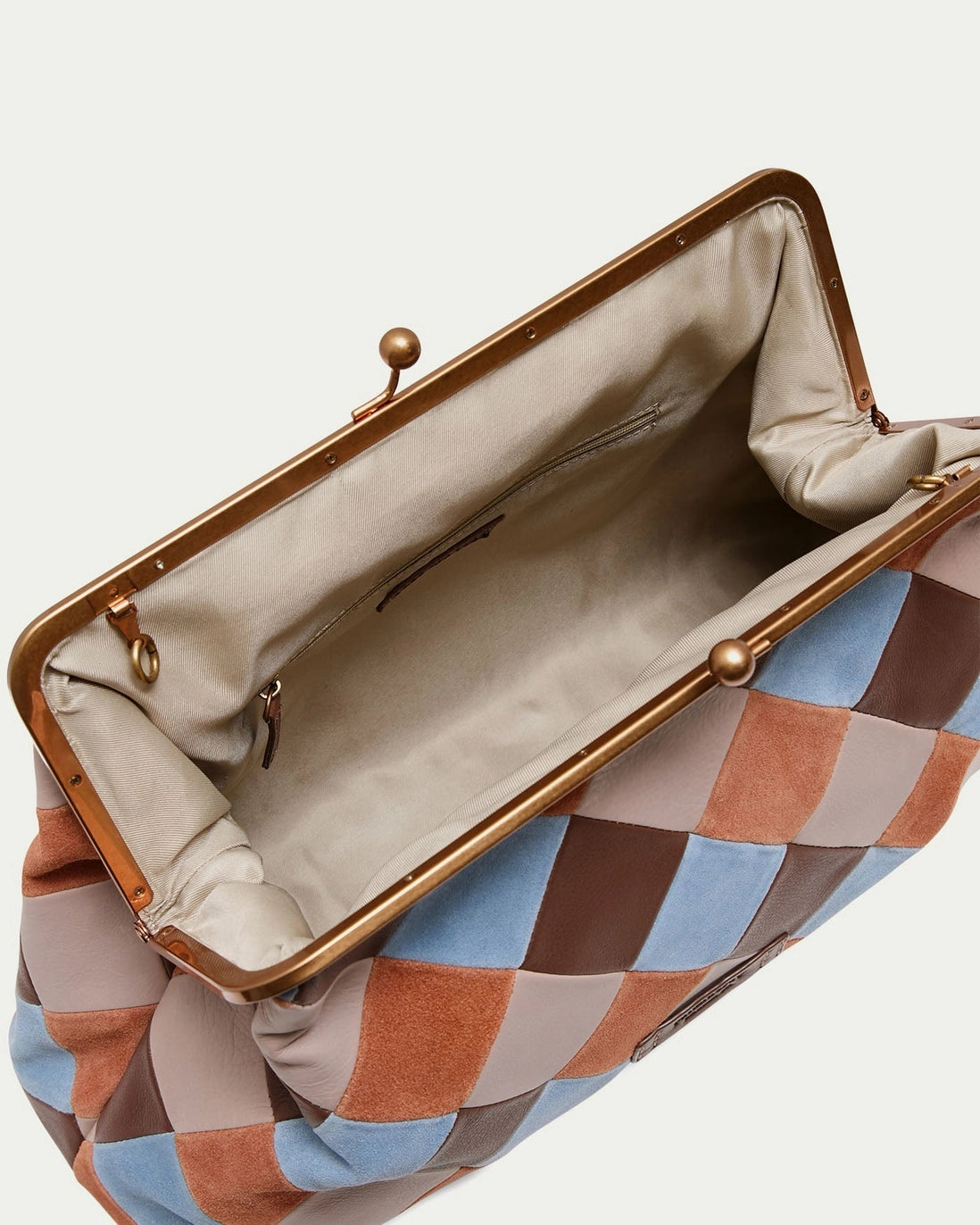 American Leather Co. Grace Oversized Clutch with woven leather patchwork, vintage-inspired kisslock frame, and removable crossbody strap.