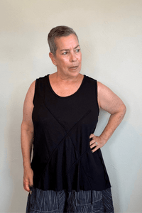 Corded sleeveless tank shown in black and white, with a scoop neckline, relaxed A-line silhouette, abstract raised crisscross cord detailing on the front, softly uneven raw-edge hem, and a clean unembellished back.