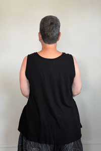 Corded sleeveless tank shown in black and white, with a scoop neckline, relaxed A-line silhouette, abstract raised crisscross cord detailing on the front, softly uneven raw-edge hem, and a clean unembellished back.