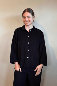 Gertie's 2167 Corduroy Big Shirt, an oversized fine-wale corduroy button-front shirt with point collar, dropped shoulders, wide three-quarter sleeves, side slits, and a longer back hem, shown in black and olive.