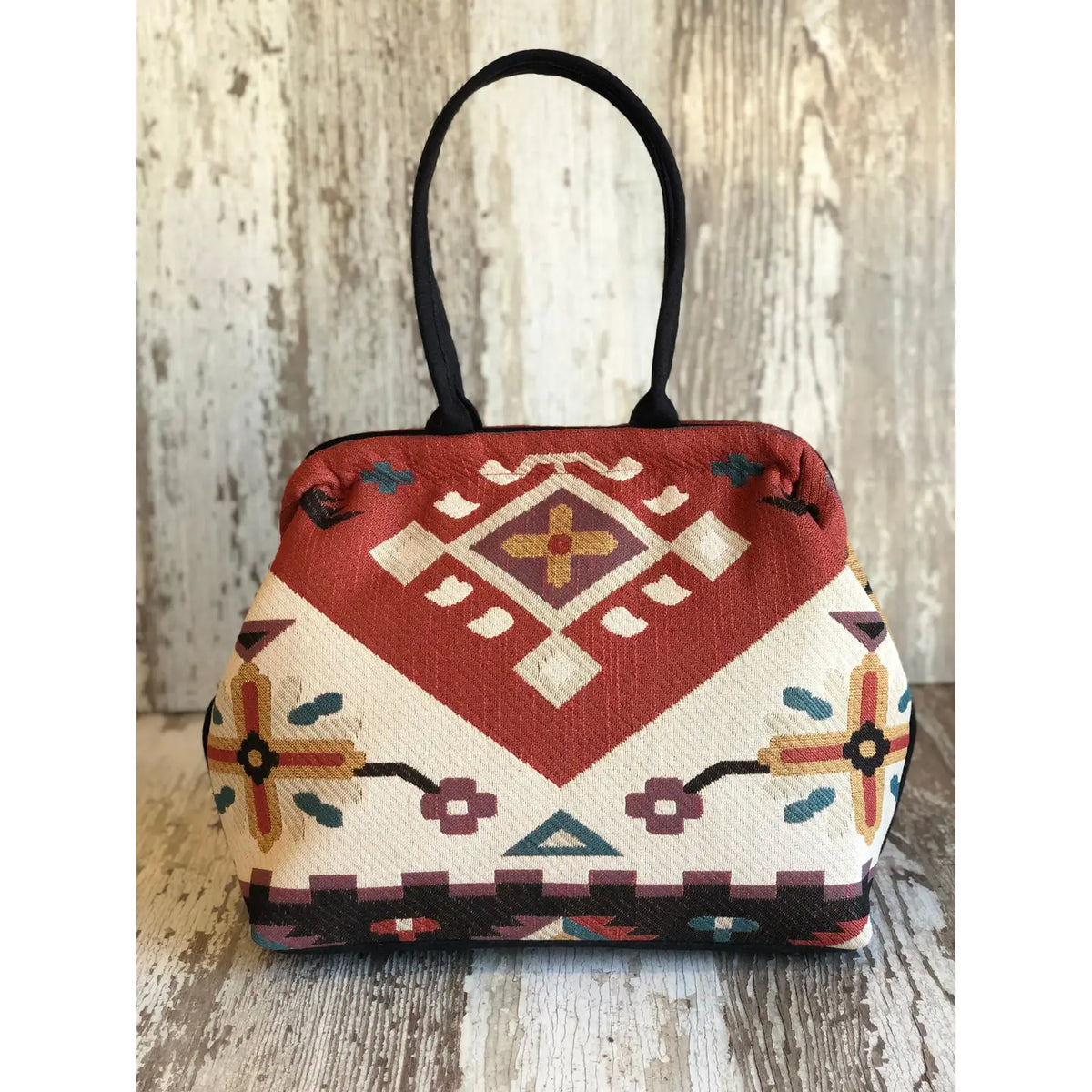Atenti Eagle Molly Snap Frame Bag with Southwest-inspired woven geometric and floral pattern, dark double handles, and structured snap-frame silhouette.