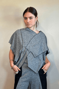 Model wearing the Kozan Fari draped top in heathered gray with black contrast edging, shown from front and back, including a full outfit view with coordinating pants.