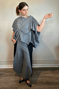 Model wearing the Kozan Fari draped top in heathered gray with black contrast edging, shown from front and back, including a full outfit view with coordinating pants.