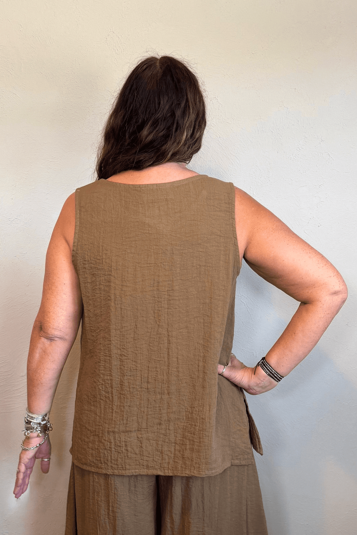 Gertie's 1050 Gail's Tank in Winter Olive, featuring a sleeveless relaxed A-line silhouette, round neckline, crinkled texture and deep side slits.