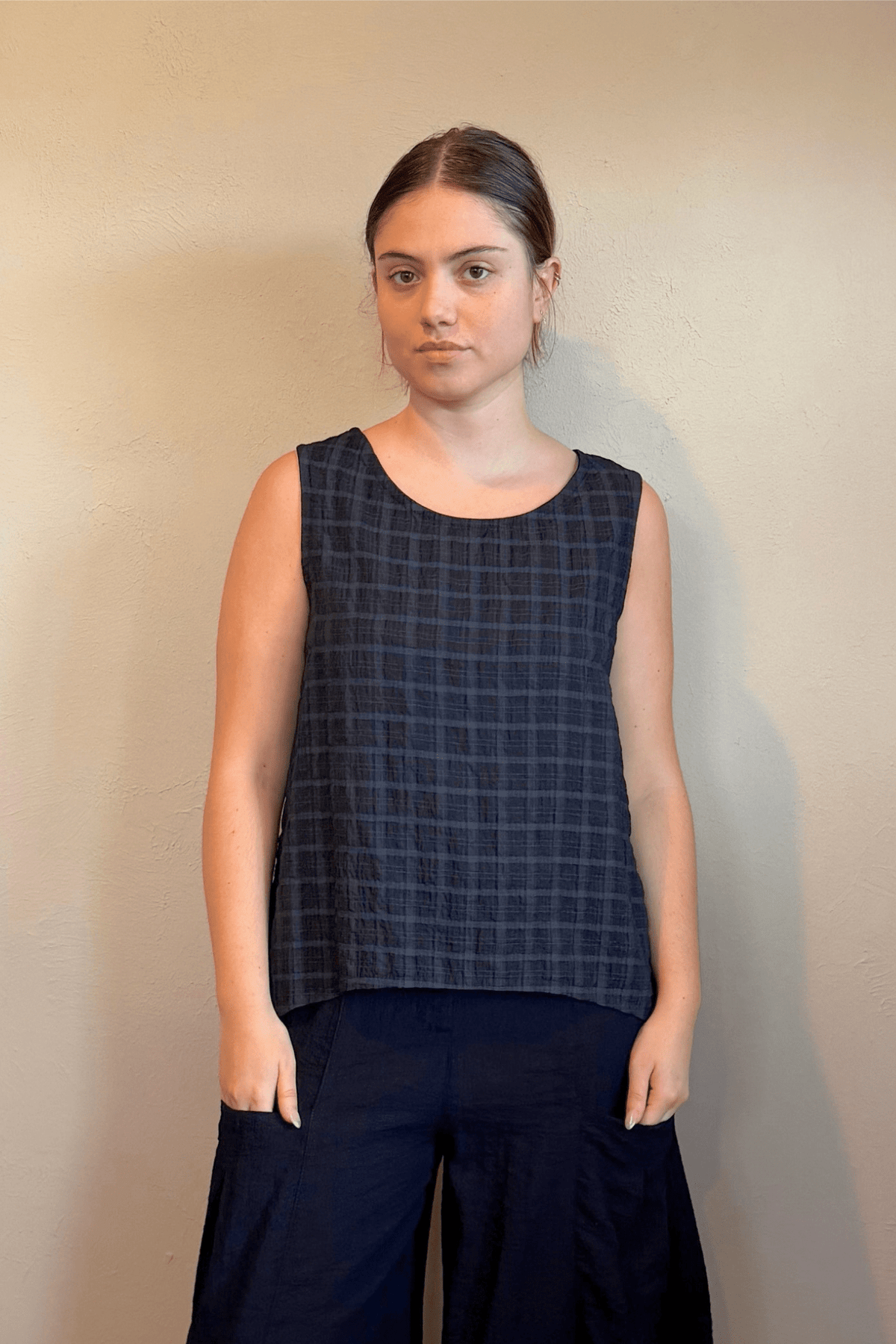Gertie's 1052 Gail's Tank in Indigo tonal check Travel Crinkle fabric, with a sleeveless A-line silhouette, scoop neckline, and side slits.