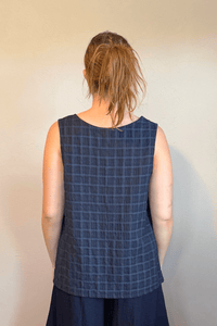 Gertie's 1052 Gail's Tank in Indigo tonal check Travel Crinkle fabric, with a sleeveless A-line silhouette, scoop neckline, and side slits.
