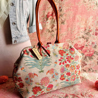 Atenti Gemma Molly handbag with vintage-inspired floral print, rust-colored double handles, spotted frame trim, and organized lined interior